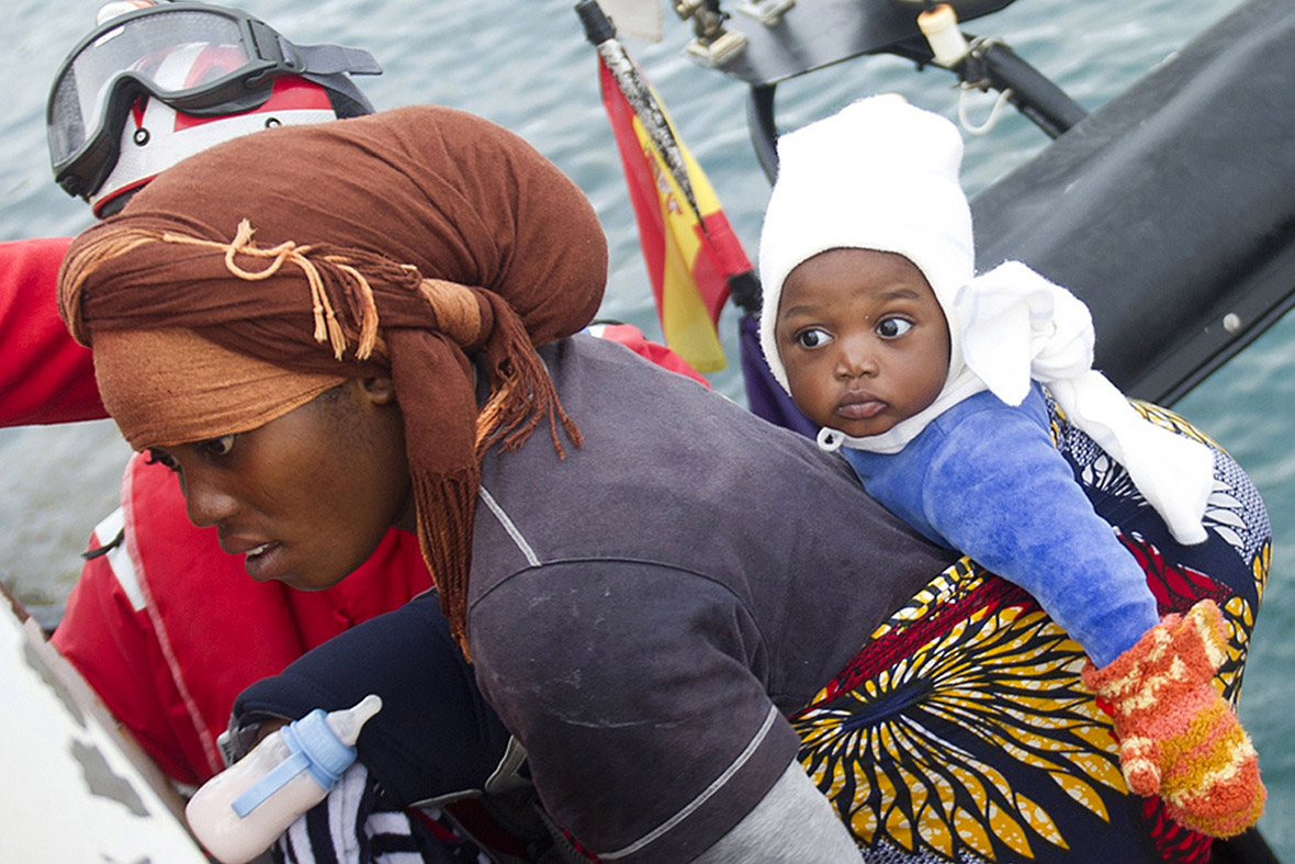 A rescued woman and her baby disembark from a Spanish coast guard vessel in Tarifa.
