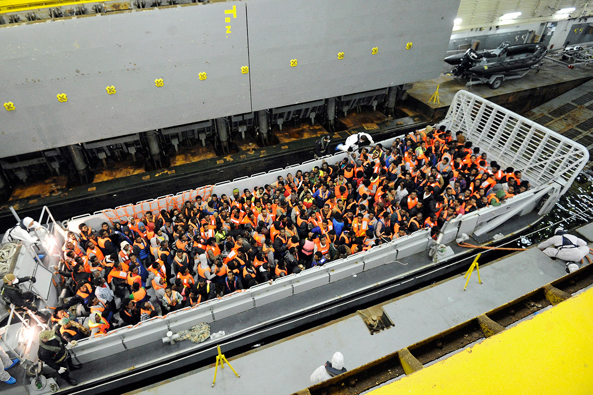 Around 250 migrants are hoisted onto a landing craft of an Italian Navy ship after being rescued in the Mediterranean between Italy and Libya.