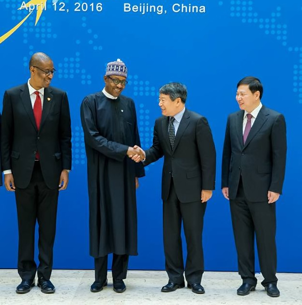 Minister of Industry, Trade and Investment, Okechukwu Enelamah and a Chinese official watch as President Muhammadu Buhari exchanges warm greetings with the Chairman of China's National Reform and Development Commission, Xu Shaoshi, at the opening of a China-Nigeria Business Forum in Beijing yesterday.