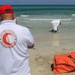 Libyans bury decomposing bodies of migrants