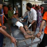 Rescue workers move a man who was injured after an explosion at the Gadani ship-breaking yard, at a hospital in Karachi