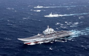 FILE PHOTO: China's Liaoning aircraft carrier with accompanying fleet conducts a drill in an area of South China Sea, in this undated photo taken December, 2016.