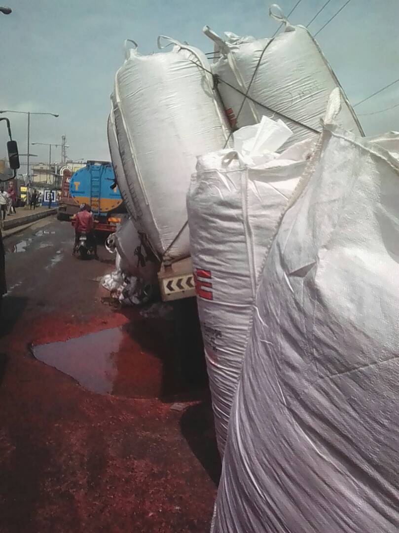 Another truck pours its load due to bad road at Apapa
