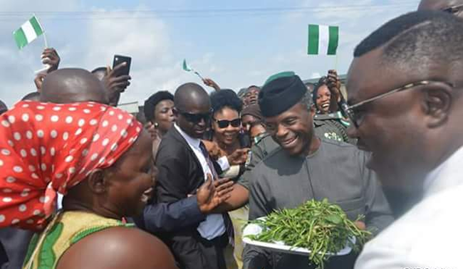 Market woman presents vegetable to Osinbajo