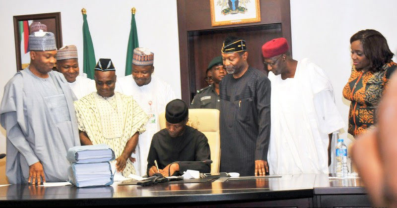 Acting President Yemi Osinbajo signing the 2017 Appropriation Act into law at the Presidential Villa in Abuja on Monday. With him from left are: Senate President Bukola Saraki; Speaker, House of Representatives, Yakubu Dogara; Senior Special Assistant to the President on National Assembly Matters (Senate), Sen. Ita Enang; Senior Special Assistant to the President on National Assembly Matters (House of Representatives), Suleiman Kawu; Minister of Budget and National Planning, Sen. Udoma Udo Udoma; Chief of Staff, Alhaji Abba Kyari; and Minister of Finance, Mrs Kemi Adeosun. 