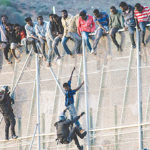 12 injured as migrants overrun Spanish enclave