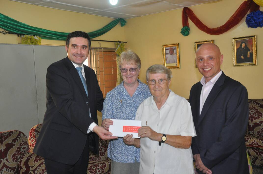 The Director of INTELS Nigeria Limited, Mr. Silvano Bellinato (left) presenting a cheque to the Medical Coordinator of the Compassion Centre, Sister Pauline Butler (2nd right). 