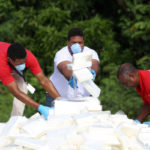 Police officers in plain clothes arrange packages of cocaine, seized from a ship stopped in international waters, before their incineration at a military base in Santo Domingo