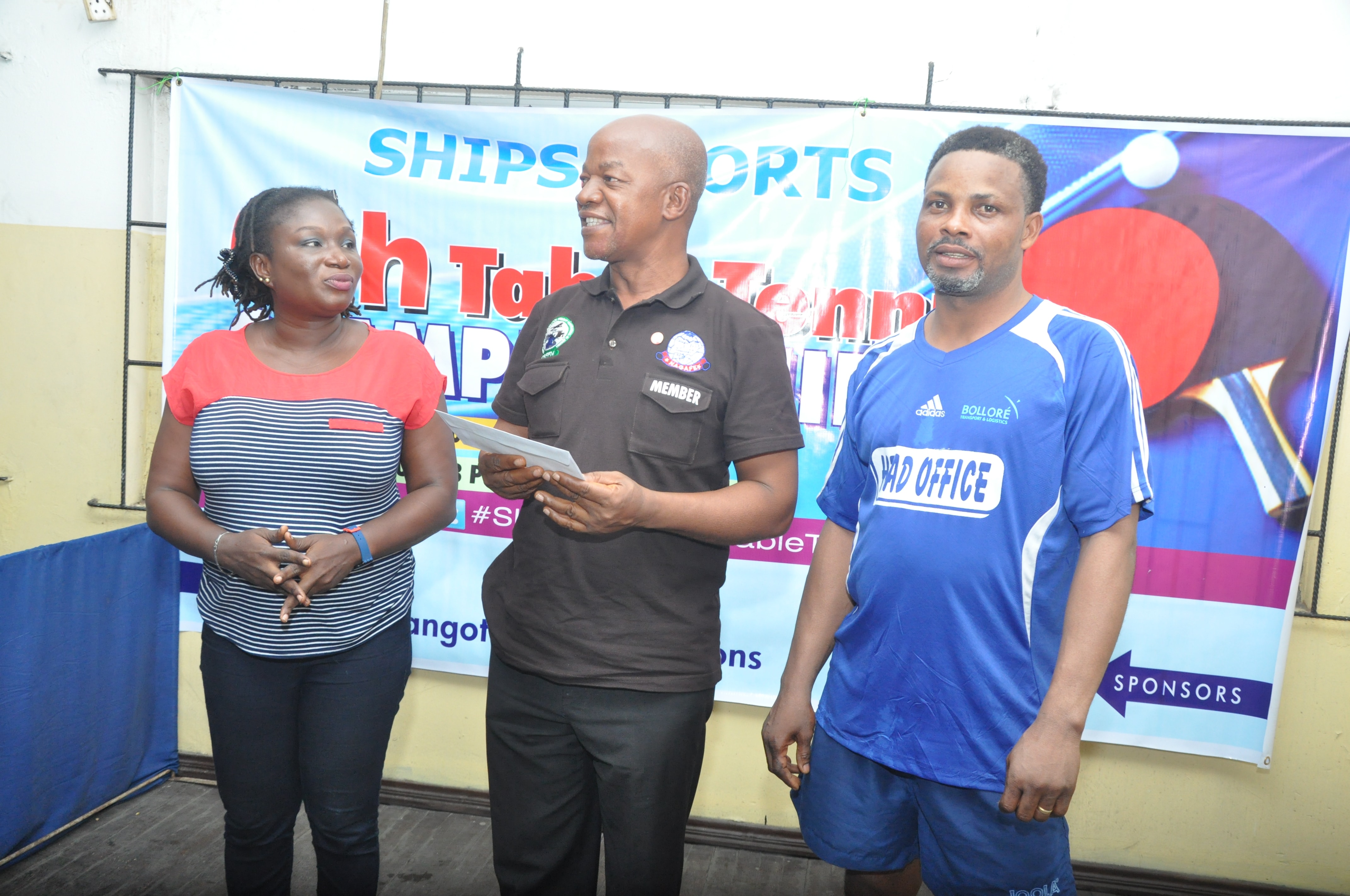 Simeon Nwonu of the National Association of Government Approved Freight Forwarders (NAGAFF) presenting cheque to the second runner of the championship, Sunday Otaru (right) as Coordinator of the competition, Eucharia Udoaka (left) watches.