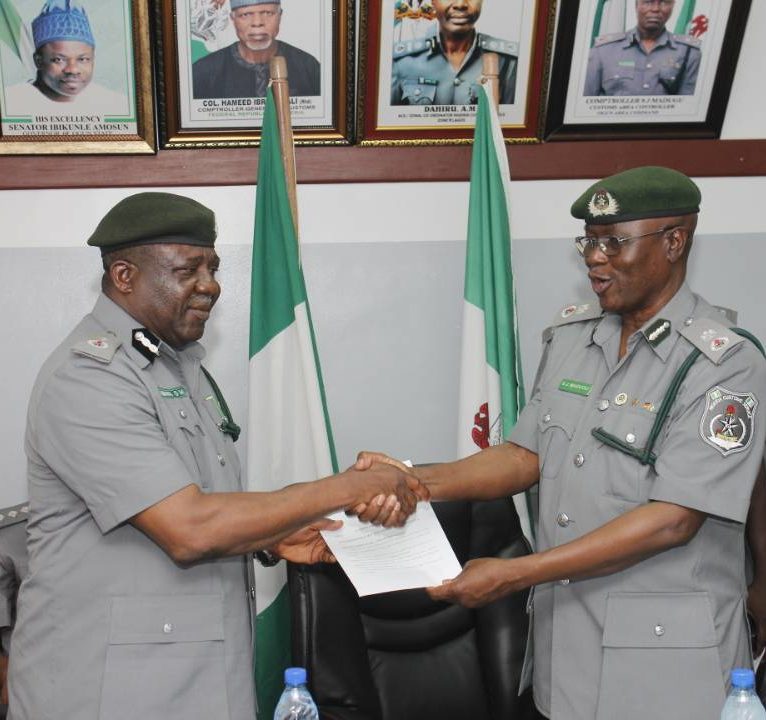 Newly appointed Controller, Ogun command of the Nigeria Customs Service, Comptroller Micheal Agbara receiving the handover note from outgoing Controller, Comptroller Sanni Madugu at a brief ceremony held at Idiroko on Wednesday.