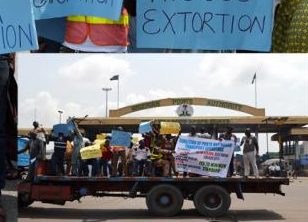 Truck drivers protest against extortion by Navy