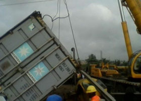 Container falls off truck, crushes two