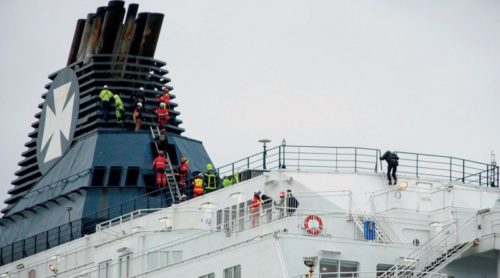 Migrants scramble aboard Calais ferry, sparking police sweep