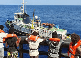 migrants disembark from Maersk Etienne in Mediterranean