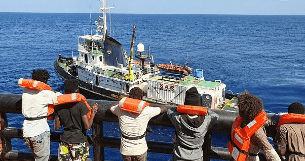 Migrants disembark from Maersk Etienne in Mediterranean