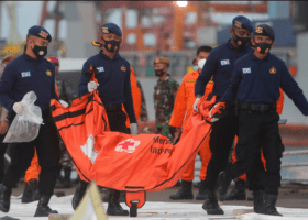 Indonesia names plane crash victim, steps up black box hunt