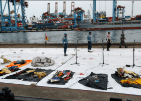 Indonesia names plane crash victim, steps up black box hunt