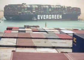 Tug boats work to free giant container ship stuck in Suez Canal