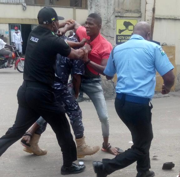Pandemonium as Civil Defense official beats up policeman in Apapa 